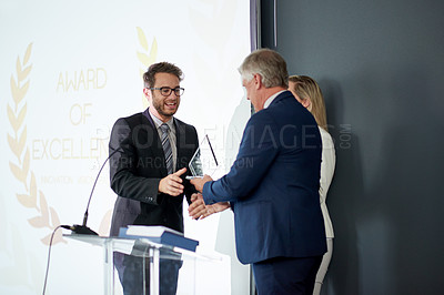 Buy stock photo Business people, award and meeting with trophy on podium for congratulations or achievement. Businessman, executive or reward with employee for promotion, winning or nomination for company excellence
