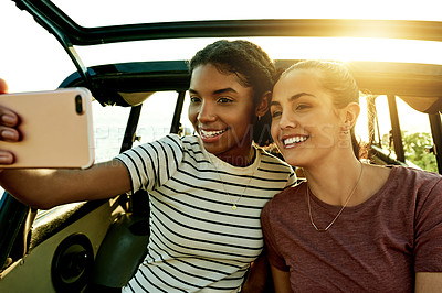 Buy stock photo Selfie, smile and car with friends on road trip together for holiday, travel or vacation. Photograph, nature and social media with happy women outdoor for profile picture with flare and destination