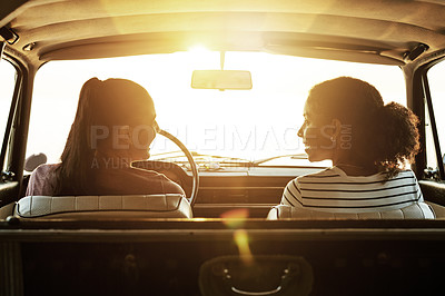 Buy stock photo Shot of two young women enjoying a road trip