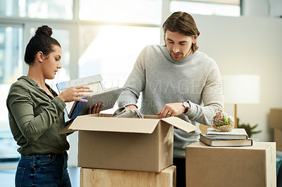 Buy stock photo Packing, box and couple in new home for moving, relocation and purchase property. Real estate, relationship and man with woman help in apartment with package for rental agreement, mortgage and house