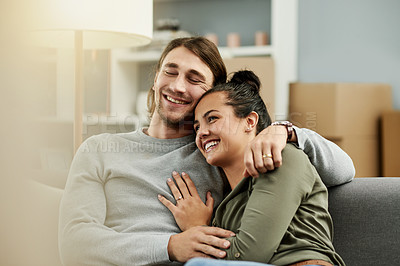 Buy stock photo Sofa, moving and happy couple hug in new home for love, property investment or mortgage. Real estate, man and woman embrace in living room for relax, relocation or bonding with partner in dream house