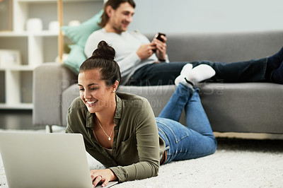 Buy stock photo Happy woman, relax and research with laptop in home for online browsing or social media on floor. Female person, man or couple with smile on computer for weekend, day off or break in living room