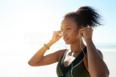 Buy stock photo Fitness, vision and woman with earphones at beach for music, audio or workout podcast. Thinking, runner and athlete with tech for marathon training, space and prepare or getting ready by ocean