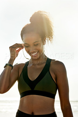 Buy stock photo Happy, athlete and woman with earphones at beach for fitness, listen to music and podcast. Thinking, female person and outdoor with playlist audio for exercise, sports training and marathon practice