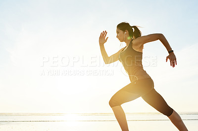 Buy stock photo Woman, running and fast at beach with earphones, training and listening to music with mock up space at sunrise. Girl, person and speed with streaming, subscription and fitness with workout in Spain