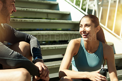 Buy stock photo Exercise, fitness and couple on break, steps and conversation for wellness in morning, summer and healthy. Outdoor, rest and people with sportswear for workout, training and laughing on stairs