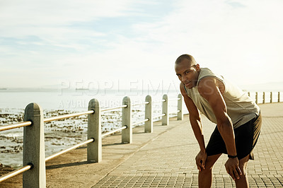 Buy stock photo Portrait, fitness or man resting at beach for wellness, endurance or cardio training outdoor. Exhausted, body fatigue or athlete on promenade on break from exercise, workout or sports with space. 