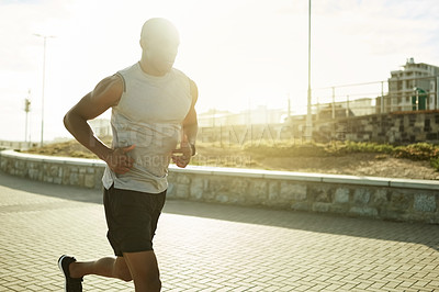 Buy stock photo Black man, fitness and running with sunset in city for workout, exercise or training on promenade. Active, male person or runner with flare for outdoor cardio, marathon or health and wellness in town