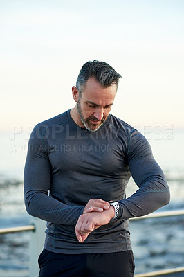 Buy stock photo Outdoor, smart watch and man with fitness, tracker and challenge with wellness, cardio and time. Person, runner and athlete with digital app, training and progress with monitor and body health
