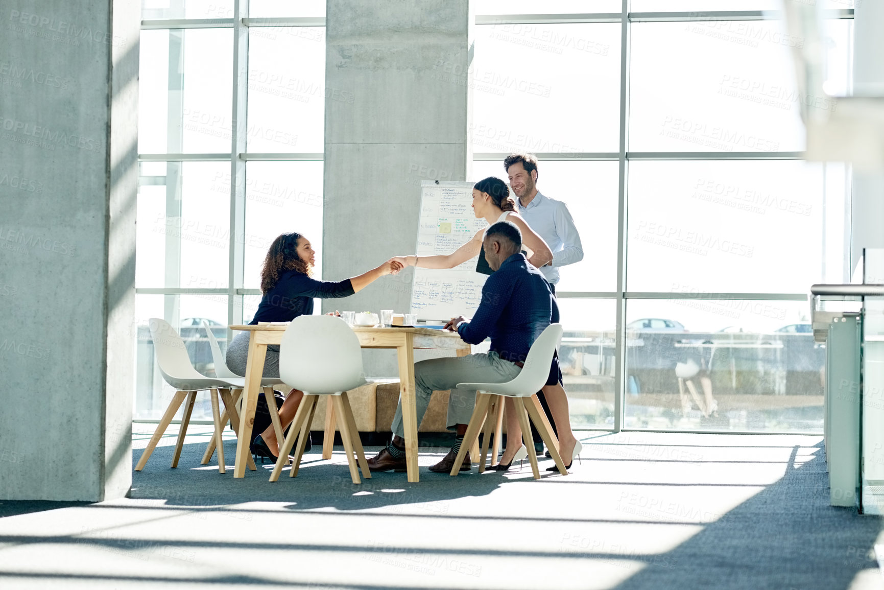 Buy stock photo Business, people and meeting with handshake in office for greeting, introduction and partnership. Employees, women and shaking hands for hiring, recruitment agreement and thank you of job opportunity