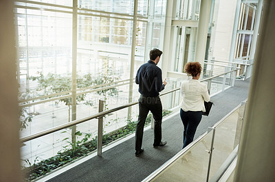 Buy stock photo Walking, team and back with business people in hotel for meeting, conference expo and partnership. Discussion, collaboration and seminar event with employees on bridge of convention center for trip