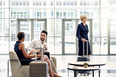 Buy stock photo Suitcase, talking and meeting with business people in airport lounge for planning, conference trip and speaking. Luggage, travel and networking event with employees for teamwork and discussion