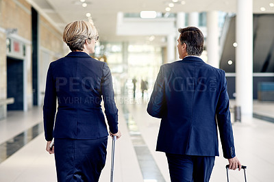 Buy stock photo Back, travel and walking with business people in airport lobby for team, suitcase and networking. Conference trip, partner and luggage with employees for layover, coworker and flight schedule