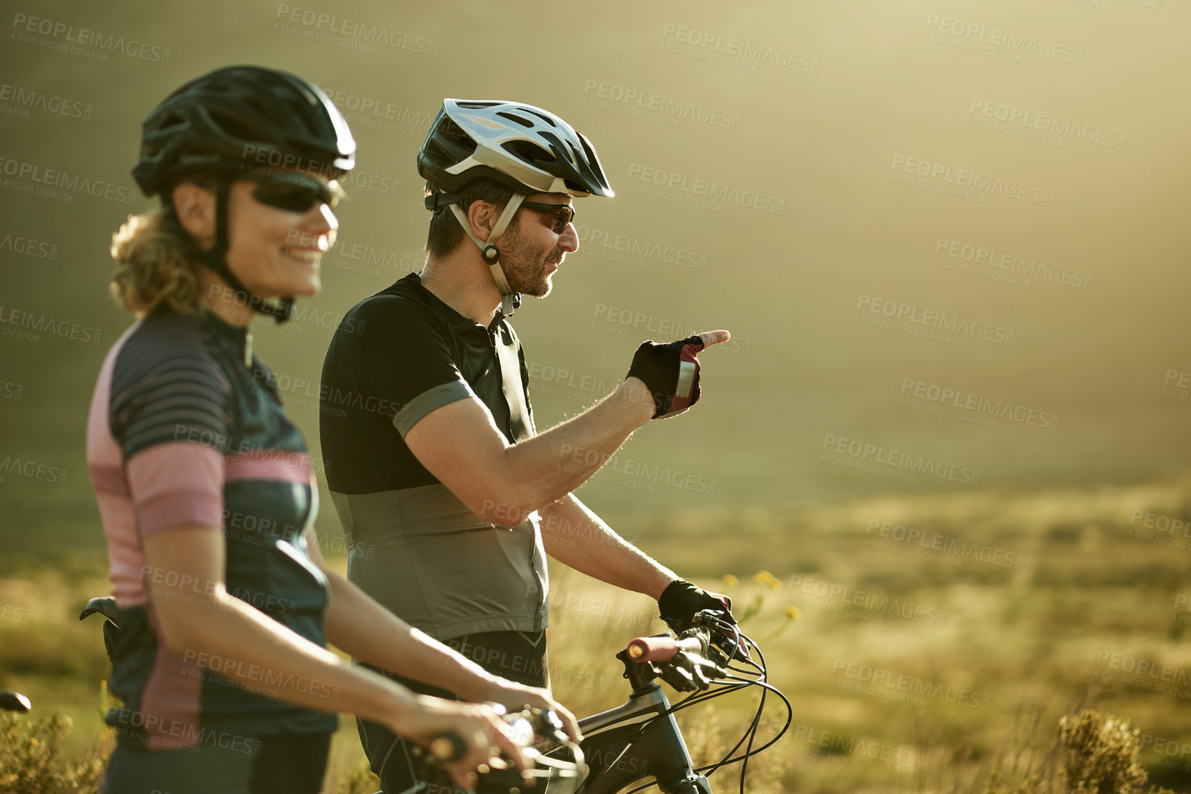 Buy stock photo Pointing, fitness and bicycle with couple in nature for triathlon training, sports athlete or team. Cardio workout, cycling partner and resting stop with man and woman outdoor for exercise and space