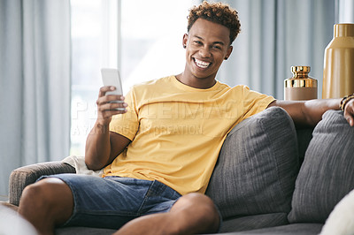 Buy stock photo Phone, portrait and smile with man on sofa in living room of home to search for social media review. App, break and me time with happy person in apartment for communication or internet browsing