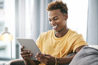 Buy stock photo Smile, tablet and weekend with man on sofa in living room of home to search for social media review. App, break and relax with happy person reading information online for me time planning or research