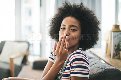 Buy stock photo Home, woman and blow kiss for love, kindness and care on valentines day in living room. African girl, flirt and romance gesture with portrait for affection emoji, expression and relax in apartment