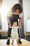 Mother, baby and learning to walk holding hands in home, education and bonding. Care, development and portrait of mama teaching kid, toddler or newborn, helping and walking, support and first steps.