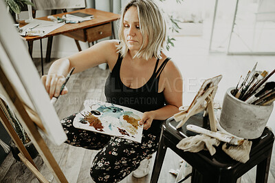 Buy stock photo Woman painting in studio with palette, canvas and creative person with talent for creativity. Focus, female artist and brush for watercolor, easel and craft of painter, drawing and design inspiration