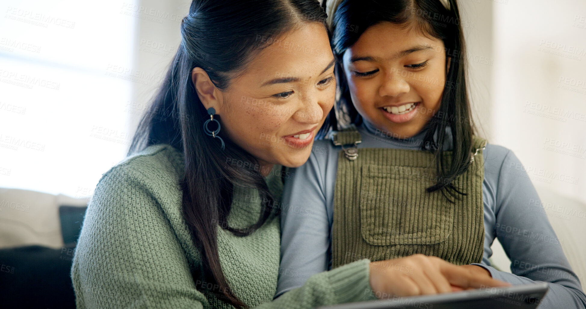 Buy stock photo Mother, child and happy with tablet in home for fun drawing app, bonding activity and development. Asian family, mom and girl kid with tech on sofa for online art puzzle, digital gaming or connection
