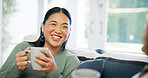 Woman, laughing and friends with coffee in house, bonding together and conversation in living room. Asian person, talking and listening to gossip in lounge, happy and discussion with beverage in home