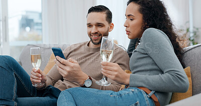 Buy stock photo Happy, couple and alcohol at house with phone, social media and browsing website on romantic date. Smile, people and champagne in home with mobile, internet search and celebration for anniversary
