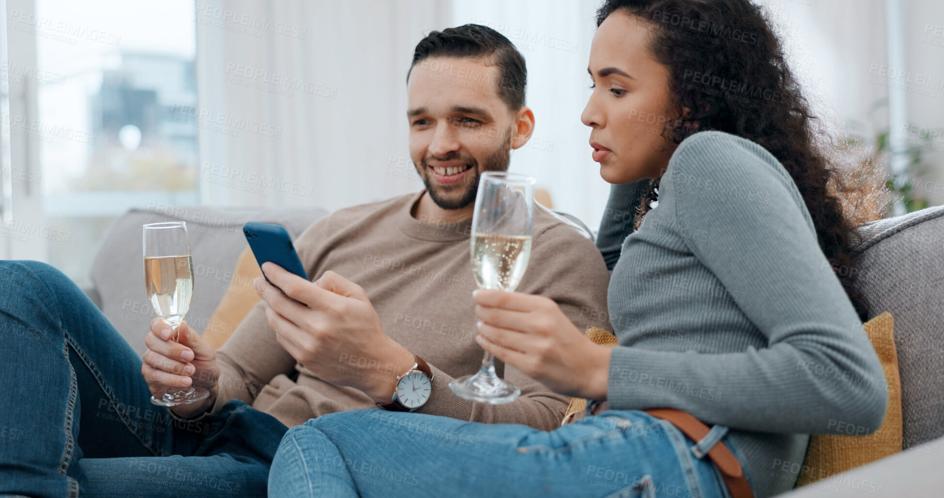 Buy stock photo Happy, couple and alcohol at house with phone, social media and browsing website on romantic date. Smile, people and champagne in home with mobile, internet search and celebration for anniversary