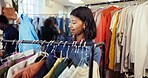 Shopping, choice or woman in store with clothing rack, outfit search or decision in trendy style. Retail, option or person in boutique with apparel, garment check or selection for fashion purchase.