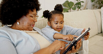Buy stock photo Grandma, scroll and child with tablet in lounge, laughing and watching cartoons with subscription. Family, online and senior black woman with daughter, happy and streaming movie with tech in house