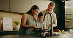 Parents, child and cleaning vegetables in home, teaching and learning domestic duties and parenting. People, smile and washing produce for cooking, guide and family help with chores for hygiene