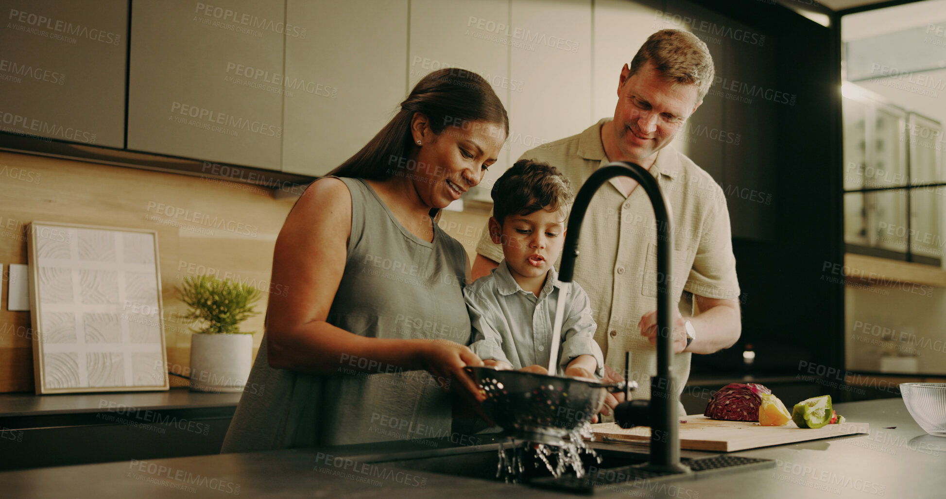 Buy stock photo Parents, child and cleaning vegetables in home, teaching and learning domestic duties and parenting. People, smile and washing produce for cooking, guide and family help with chores for hygiene