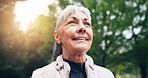 Senior, thinking and happy woman with fresh air in park for outdoor fitness, workout or exercise. Elderly, female person or daydreaming with flare, peace or calm tranquility for health or wellness