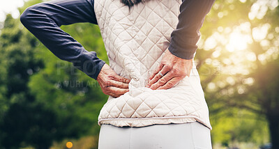 Buy stock photo Person, hands and back pain in park for outdoor fitness, bad posture or overworked strain in nature. Active, sore or massage with discomfort or wellness for muscle tension, fibromyalgia or pressure