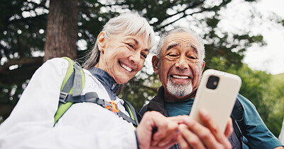 Buy stock photo Low angle, senior and happy couple with phone for hiking trail info, online map and bonding trip. Trekking, exploring and old people with navigation app and together for active lifestyle for wellness