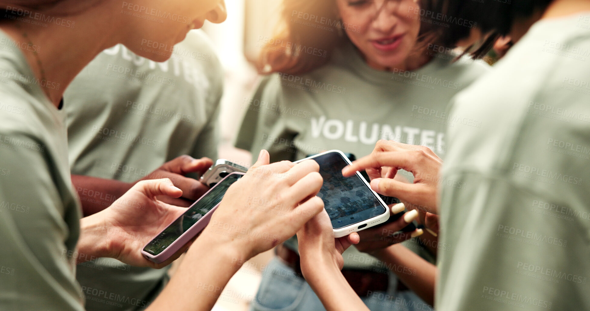 Buy stock photo Volunteer, hands and group outdoor with phone screen, review fundraising pictures or memory sharing. NGO, team and mobile in circle with event photos, progress update or caption for social media post