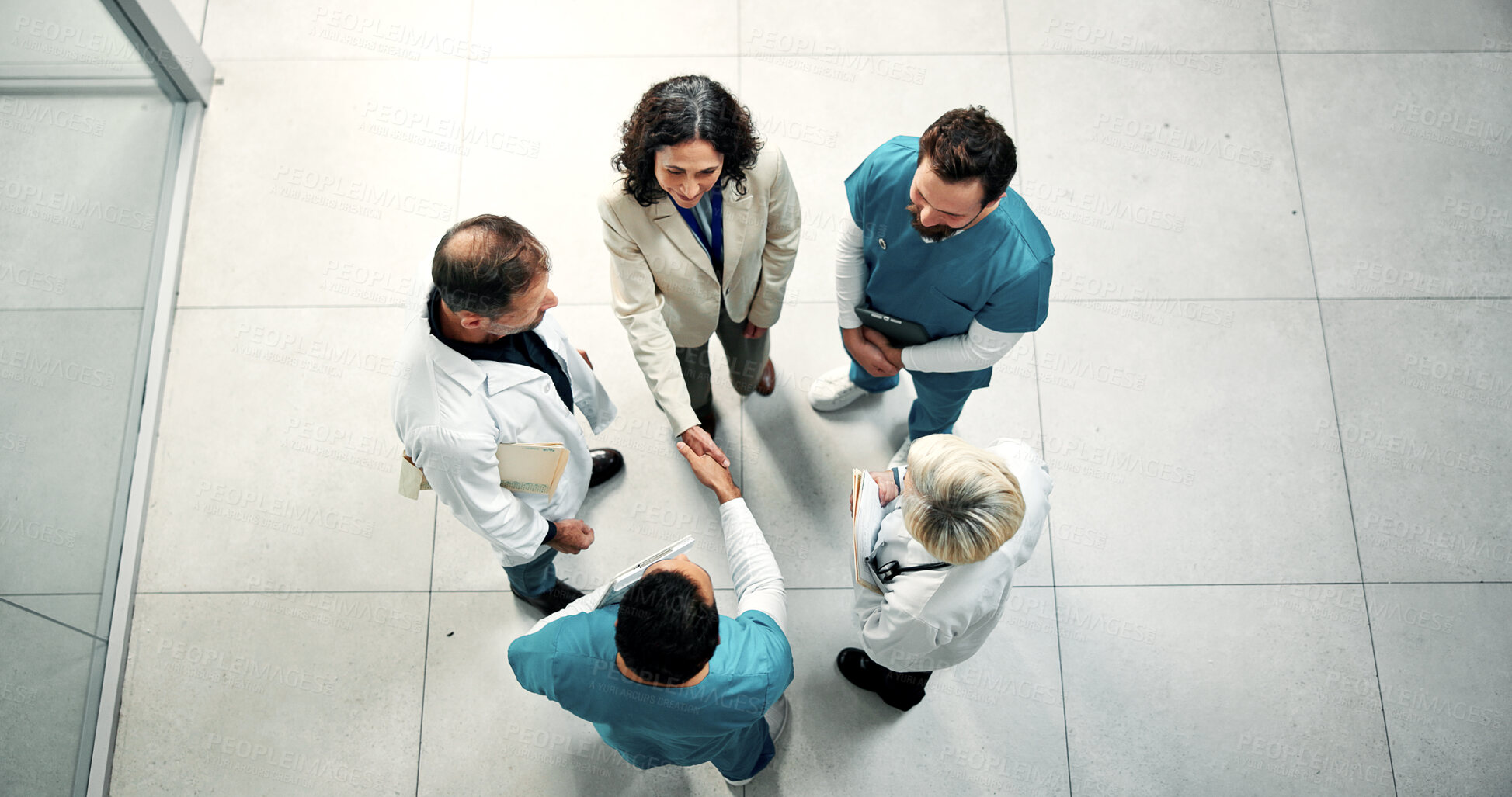 Buy stock photo Doctor, team or shaking hands with nurse for agreement, healthcare support or cooperation from above. People, smile and handshake in hospital for partnership, medical collaboration and thank you