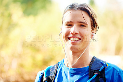 Buy stock photo Portrait, man and earphone for hiking with music outdoor for fitness, streaming and playlist. Happy, break and male person trekking in forest with smile, backpack or space on nature journey or travel