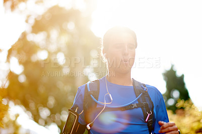 Buy stock photo Running, fitness and man in woods, training and cardio with challenge, endurance and hobby. Healthy person, outdoor and runner in forest, lens flare and wellness with routine, practice and energy