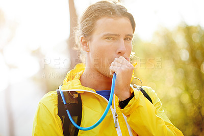 Buy stock photo Outdoor, man and hiking in portrait for drinking water, nutrition and body wellness for fitness. Nature, male person and hiker with hydration pack for H2O, thirsty and trekking break in Switzerland