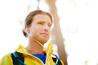 Buy stock photo Runner, training and man in forest, earphones and wellness with workout, audio and space. Person, outdoor and athlete in park, listening to music and podcast with challenge, energy and practice