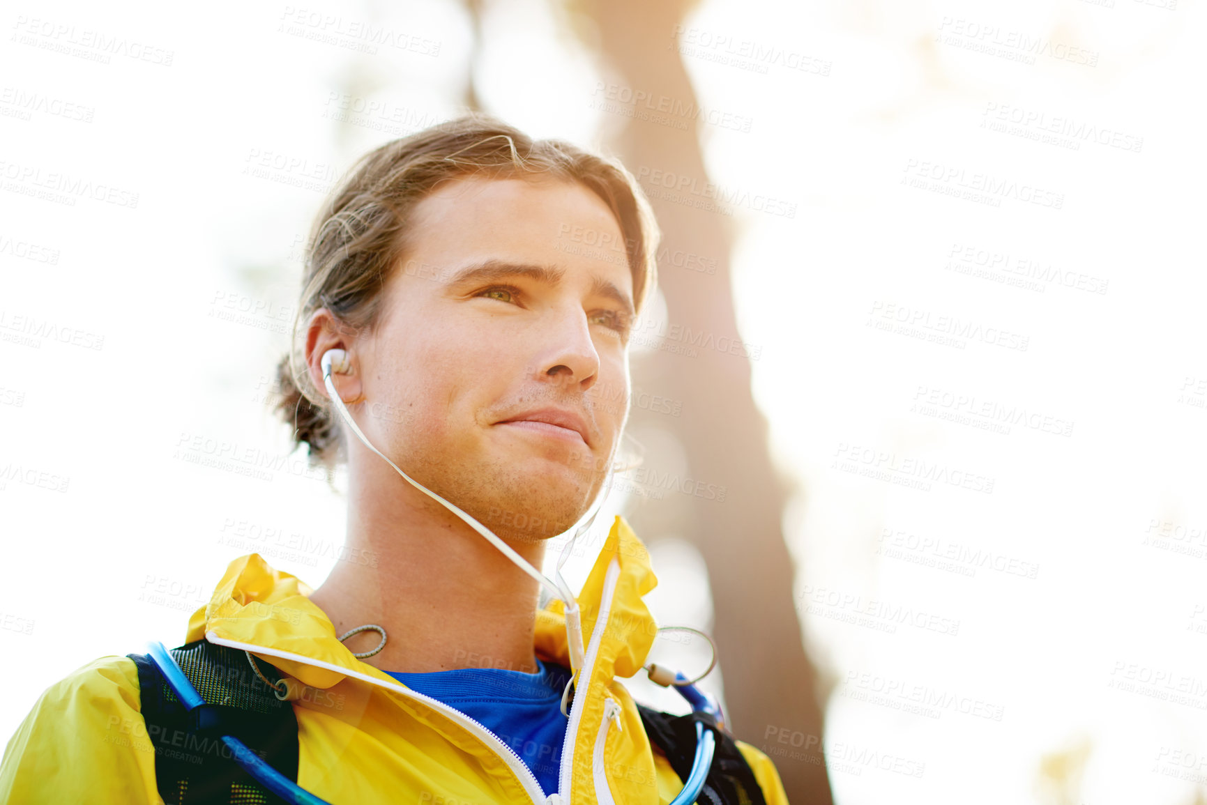 Buy stock photo Runner, training and man in forest, earphones and wellness with workout, audio and space. Person, outdoor and athlete in park, listening to music and podcast with challenge, energy and practice