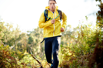 Buy stock photo Man, fitness and running in forest for workout, exercise or cardio training in outdoor nature. Active, male person or runner with backpack or bag in woods for sport, health and wellness in wilderness