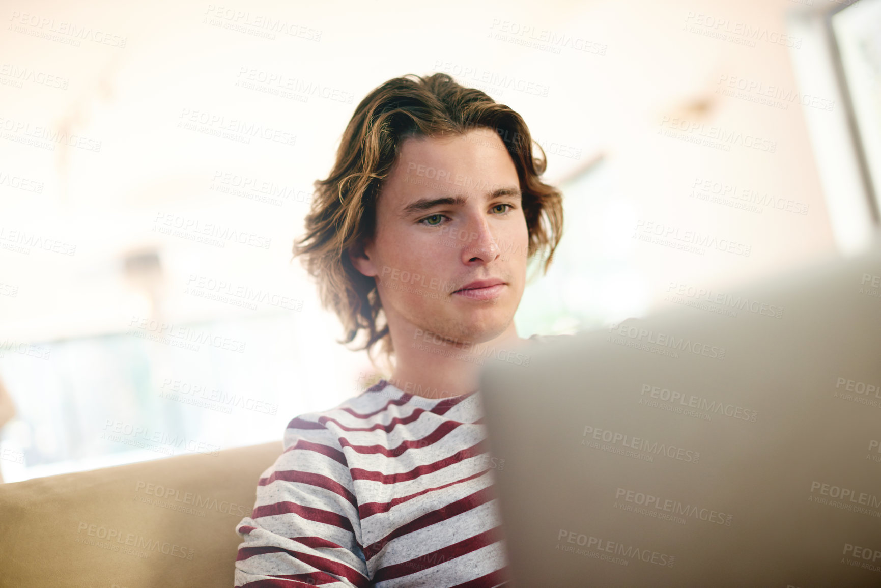 Buy stock photo Laptop, thinking and man on sofa for email, reading and university scholarship application in home. Tech, research and male student in living room for college admission test, exam or study assignment
