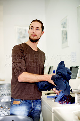 Buy stock photo Thinking, man and washing clothes with machine for cleaning service, dirty apparel and hygiene. Male person, loading or equipment for laundry, fabric maintenance and cleanliness routine at laundromat