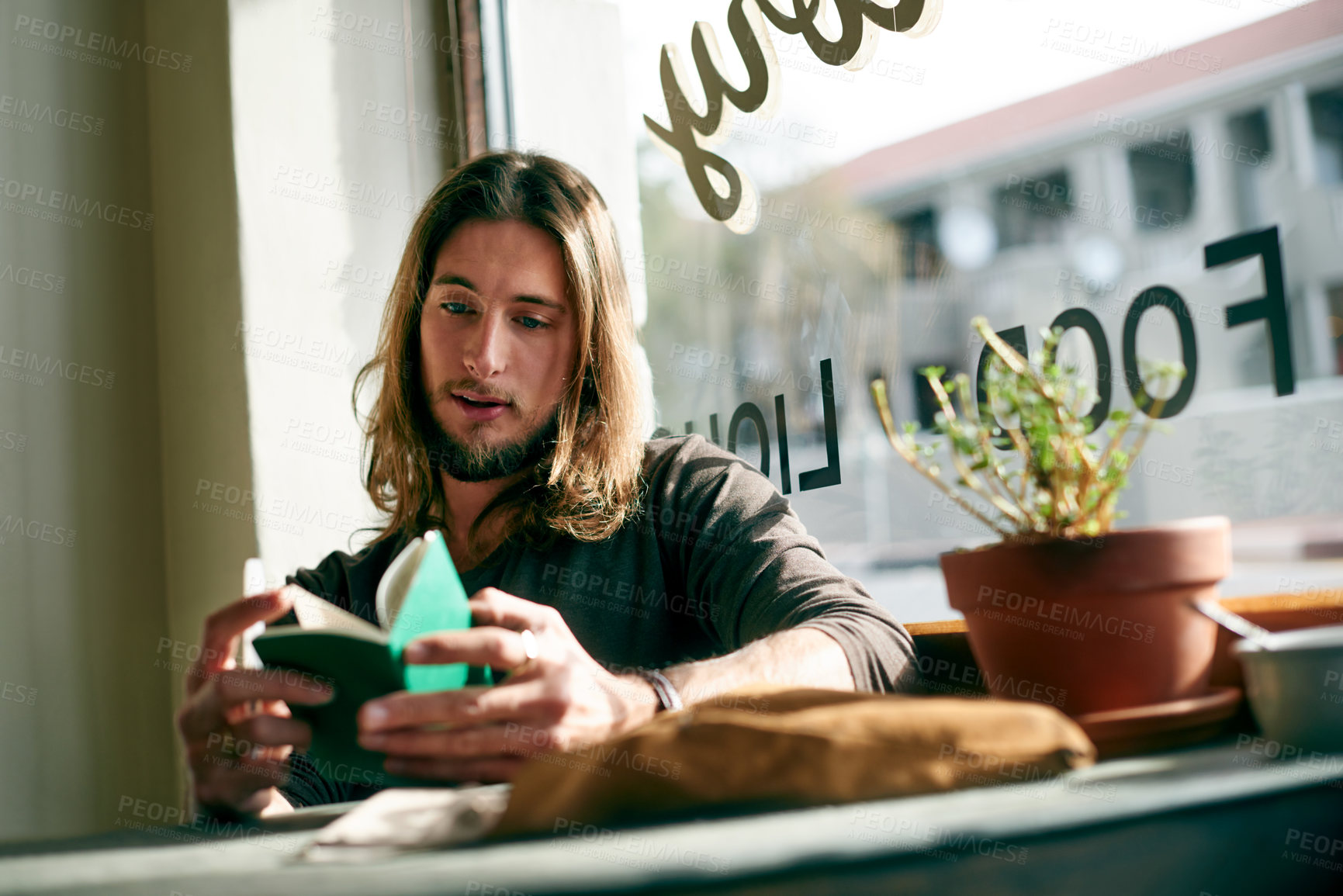 Buy stock photo Man, tourist and reading with notebook in cafe for travel destination, checklist or daily schedule. Male person, traveler or memo with to do list for reminder, tasks or planning trip in restaurant