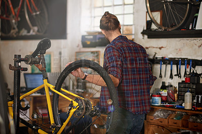 Buy stock photo Mechanic, workshop and man with bicycle for repair, fixing and bike maintenance with tools. Small business, cycle technician and person with equipment for wheel, gears and cycling service in garage