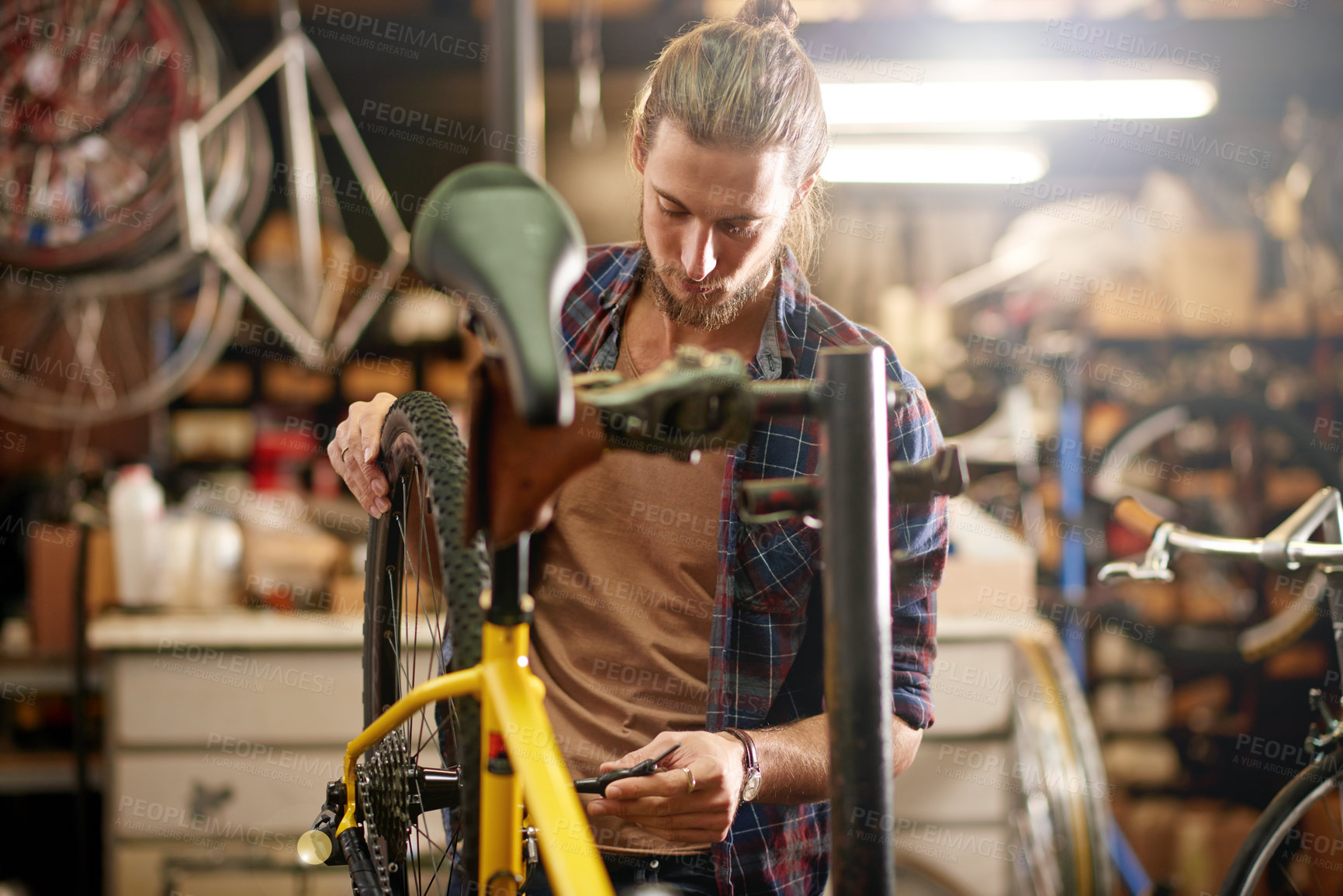 Buy stock photo Man, wheels and bicycle repair at workshop with thinking, equipment and problem solving at small business. Person, technician and bike mechanic with gears, safety check and chain inspection at garage