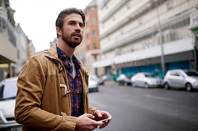 Buy stock photo Man, travel and waiting on lift in city for taxi pickup, morning commute and ride for public transport. Male person, phone and looking with cab delay, bus schedule and tourist for adventure in urban