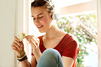 Buy stock photo Flower, headphones and girl relax with music for streaming service, radio playlist or favorite love song. Teenager, rose and listen to audio on technology for romantic album, sound or podcast in home