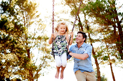 Buy stock photo Father, child and happy on swing at park for playing together, freedom and holiday adventure. Family fun, dad and push girl kid on playground equipment for bonding, sensory stimulation and adrenaline
